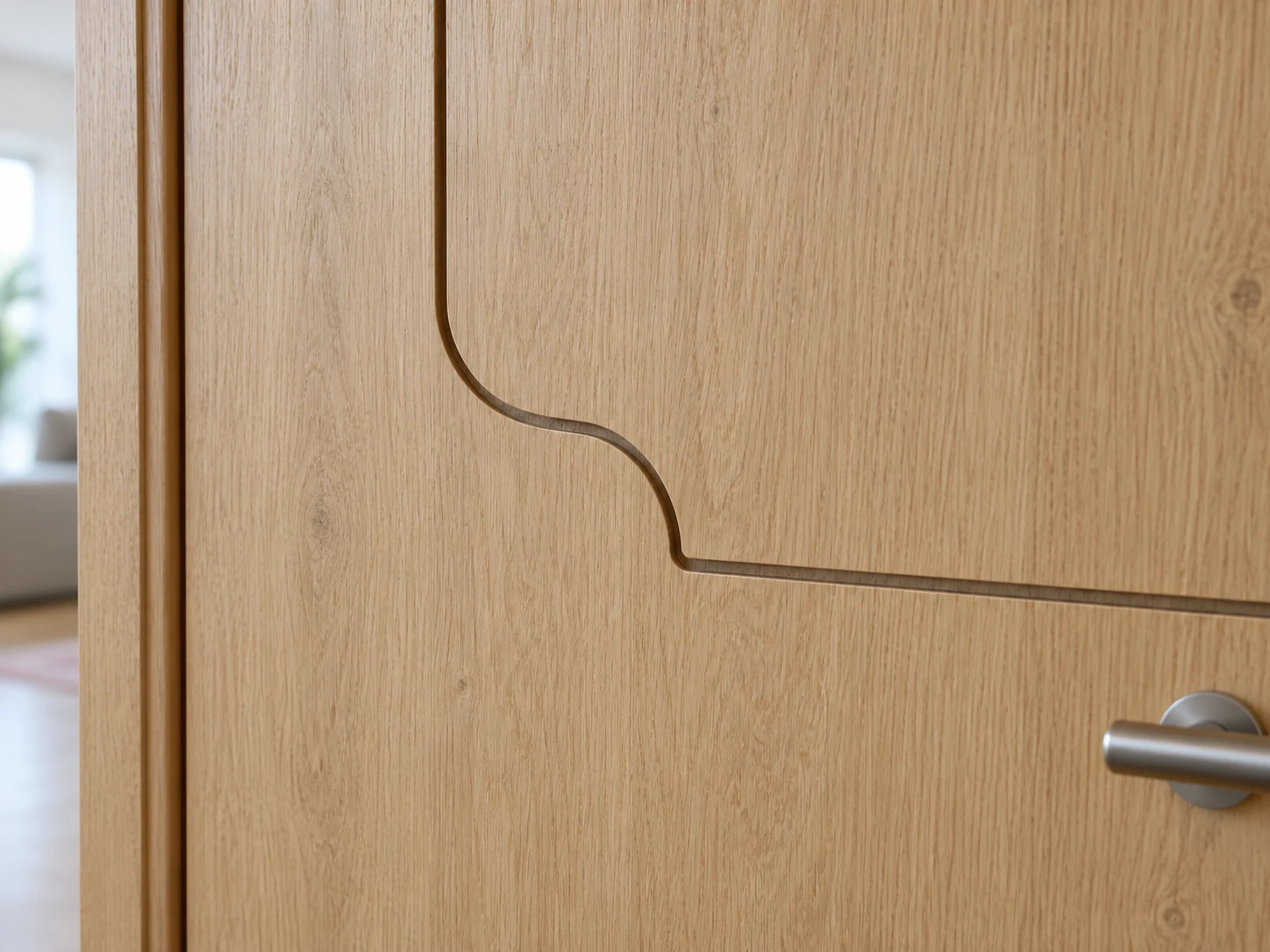 Close view of a curved routed line turning into a horizontal line on a light oak-finish door