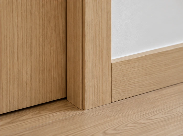 Installed woodgrain door frame, casing and matching skirting